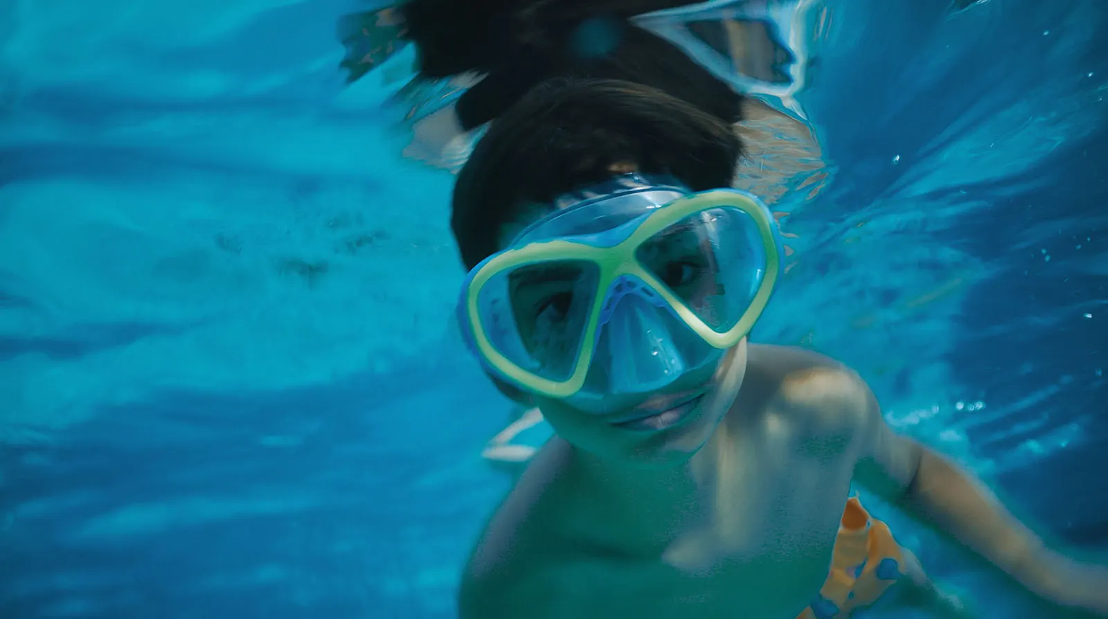 Boy swimming underwater with snorkel mask underwater video