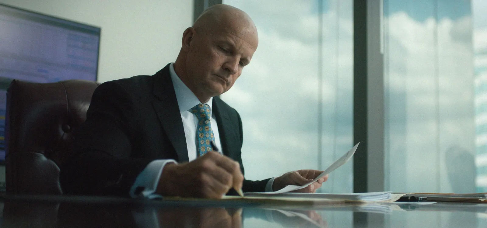 Jeff Hausinger writing a letter in his office for b roll