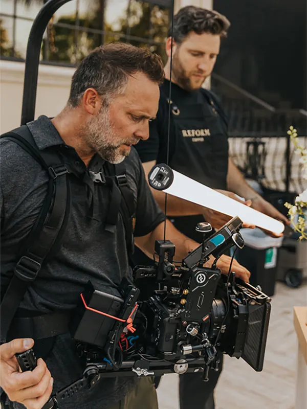 Videographer capturing social media content with handheld camera on set